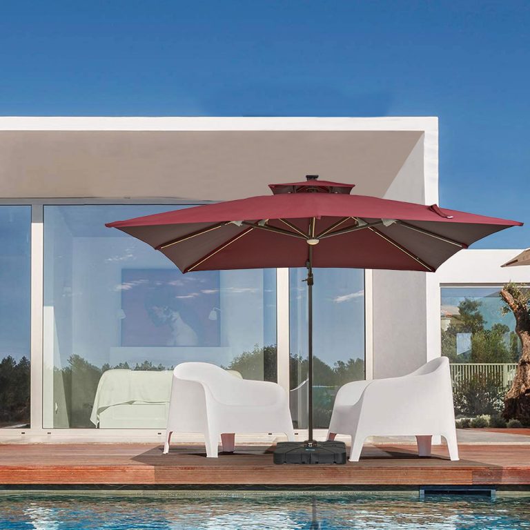A cantilever solar-lit umbrella illuminating a poolside lounge area at dusk