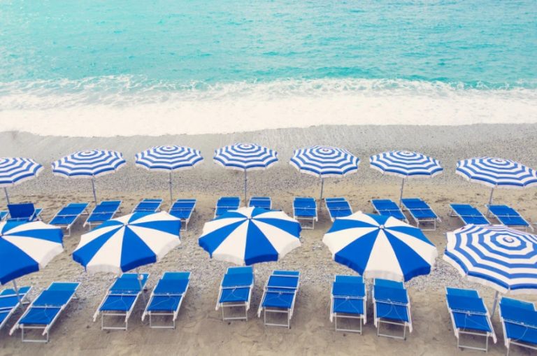 White and blue striped parasols on a Greek beach